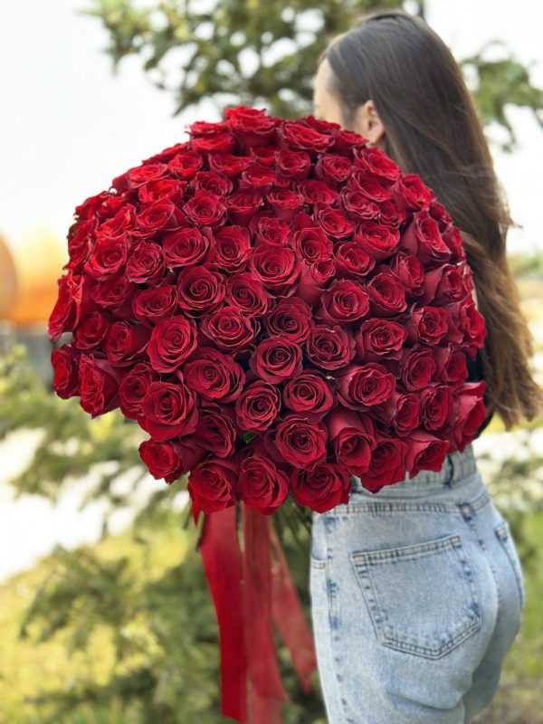 A close-up view of a vibrant bouquet of 100 roses, showcasing a variety of colors including red, pink, and white. The velvety petals and delicate fragrance of the roses evoke a sense of love and romance. The bouquet is expertly arranged and beautifully presented, making it an ideal gift for special occasions or expressions of affection.