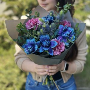 A stunning bouquet named "Nature's Delight" showcases a vibrant and textured assortment of blooms and foliage. The bouquet captures the essence of spring, exuding joy and natural beauty. With its captivating colors and varied textures, this arrangement is perfect for adding a touch of vibrant elegance to any occasion.