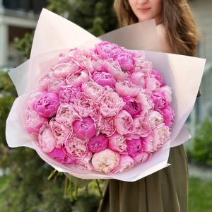 A stunning arrangement of 50 peonies in full bloom, showcasing a variety of captivating colors. The lush petals and intricate details of the peonies create a sense of elegance and natural beauty. This collection is perfect for adding a touch of sophistication to any floral arrangement or event.