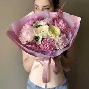 A breathtaking bouquet named "Floral Melody" showcases a combination of peonies, anemones, ranunculus, roses, and astilbe. The vibrant and diverse blooms come together in a harmonious blend, creating a visually stunning display of colors and textures. This bouquet radiates elegance and charm, making it an ideal choice for adding a touch of enchantment to any occasion or celebration.