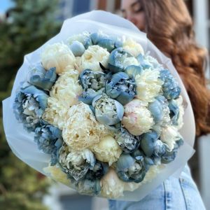 A stunning bouquet named "Whispering Elegance" showcases the beauty of white and blue peonies. The delicate white peonies and serene blue peonies create an elegant and captivating blend of colors. This arrangement exudes grace and sophistication, making it an ideal choice for adding a touch of elegance to any occasion or celebration.