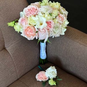Bridal bouquet with peonies, freesia, spray roses, lisianthus, eucalyptus, and roses