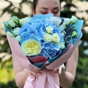 "Mystic Floral Elegance" bouquet featuring hydrangeas, roses, spray roses, lisianthus, and eryngium.