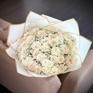 An enchanting bouquet of 36 roses accompanied by delicate gypsophila, also known as 'baby's breath'.