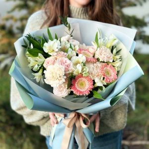 A colorful bouquet filled with gerbera daisies, dianthus, astrantia, and spray roses, perfect for brightening your day or gifting to a loved one.