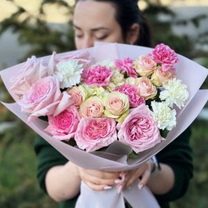 A breathtaking bouquet called "Rose Symphony" showcasing classic roses, spray roses, and dianthus in a harmonious blend of colors and scents.