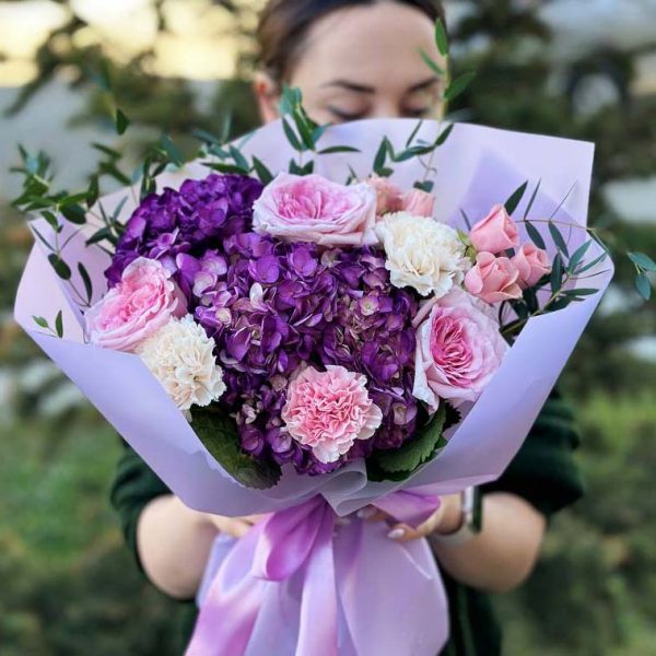 An elegant bouquet named "Tranquil Blossom Harmony" showcasing roses, spray roses, dianthus, and eucalyptus in a beautifully arranged display of tranquility and grace