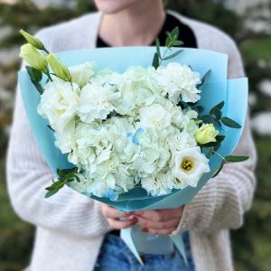 A stunning bouquet named "Luxe Garden Radiance" highlighting hydrangeas, lisianthus, and dianthus in a display of botanical elegance and luxury.