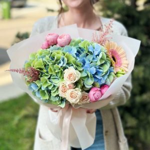 A close-up view of the "Hydrangea Dreams" bouquet, highlighting the exquisite hydrangeas, spray roses, gerberas, and astilbe in full bloom, creating a garden-inspired masterpiece.