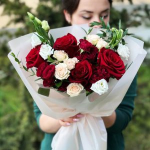 A close-up view of the "Elegant Rose Medley" bouquet, showcasing a beautiful mix of roses, spray roses, eustoma, and eucalyptus leaves in full bloom, radiating elegance and charm.