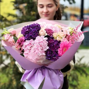 The 'Floral Romantic Surprise' bouquet featuring hydrangeas, astilbe, dianthus, lisianthus, spray roses, and gerberas.