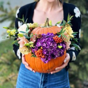An image of the "Pumpkin Floral Fusion" arrangement, featuring a pumpkin vase filled with sunflowers, daisies, and asters, perfect for autumn celebrations and seasonal decor.