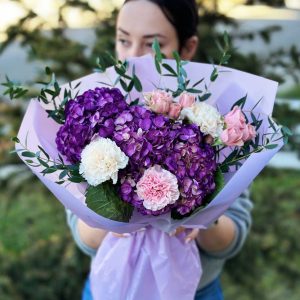 Harmony in Blooms bouquet with hydrangeas, dianthus, spray roses, and eucalyptus.