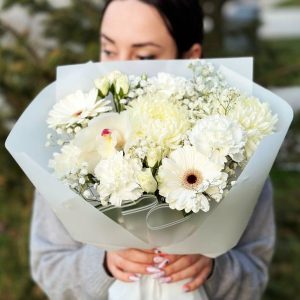 A close-up view of the Chrysanthemum Gerbera Delight floral arrangement featuring vibrant chrysanthemums and cheerful gerbera daisies with delicate gypsophila accents.