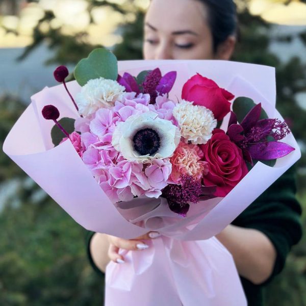 A stunning bouquet showcasing hydrangeas, dianthus, anemones, roses, eucalyptus, dried florals, and skimmia. Ideal for weddings, special occasions, or meaningful gifts, radiating opulence, elegance, and harmony.