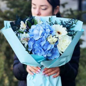 A close-up view of the "Enchanted Garden Serenity" bouquet, highlighting hydrangeas, roses, astrometry, lisianthus, astilbe, and gypsophila in a serene and elegant floral composition.