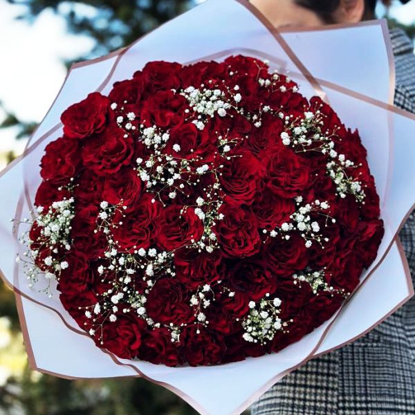 An enchanting bouquet of delicate roses and airy gypsophila, perfect for romantic occasions.