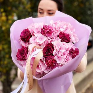 A refined bouquet featuring hydrangeas, roses, and dianthus, combining classic and sophisticated beauty with elegance.