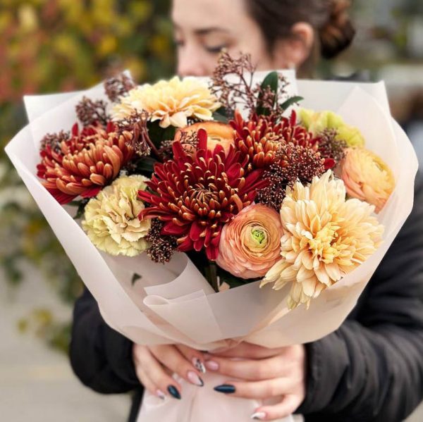 Image of the "Chrysanthemum Dianthus Ranunculus Splendor" bouquet showcasing vibrant chrysanthemums, fragrant dianthus, elegant ranunculus, and glossy skimmia, ideal for special occasions and celebrations.