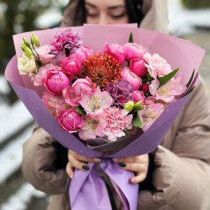 Image of the "Leucospermum Radiance" bouquet, showcasing vibrant Leucospermum, spray roses, astromeria, dianthus, and lisianthus, a burst of fiery and soft colors with delightful fragrances, suitable for special occasions and decor.