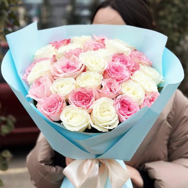 Image of the "Rose Radiance" bouquet, featuring a stunning arrangement of roses in classic red, blush pink, and creamy white hues. The lush greenery enhances the beauty of the roses, creating a visually striking and romantic composition.