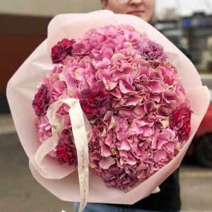 An image of the "Harmony in Blooms" bouquet showcasing a beautiful arrangement of hydrangeas and dianthus. The vibrant colors and lush blooms create a visually pleasing and harmonious display.