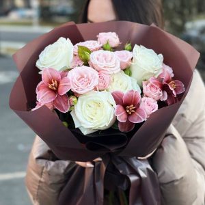 An image of the "Rose Petal Symphony" bouquet, showcasing a blend of classic roses, spray roses, and tulips. The varying colors and textures create a visually stunning arrangement that embodies the essence of love and celebration.