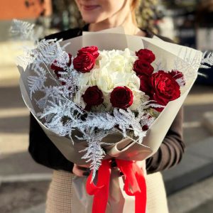 A mesmerizing image of the "Ethereal Elegance Bouquet" showcasing a blend of hydrangea, classic roses, spray roses, and asparagus fern. The varied textures and hues create a visually stunning arrangement, embodying the essence of romance and elegance.