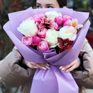 A captivating image of the "Rhapsody in Roses and Tulips" bouquet, showcasing a harmonious mix of classic roses, playful spray roses, and vibrant tulips. The blooms come together in a visually stunning arrangement, creating a poetic expression of love and beauty.