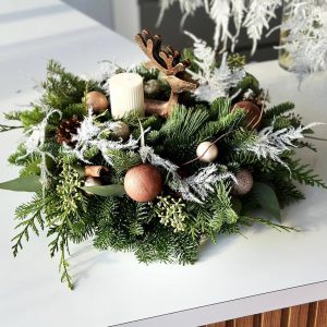 Festive Forest Glow: Christmas wreath with a graceful reindeer and a warm, flickering candle. Ideal for creating a cozy and enchanting holiday atmosphere in your home.