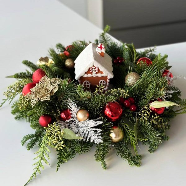 Festive Homestead: Table centerpiece with a charming miniature house and vibrant red Christmas ornaments, creating a whimsical and festive atmosphere for your holiday dining experience.