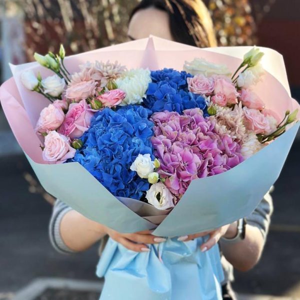 Colorful Symphony: Rich bouquet with hydrangeas, roses, spray roses, lisianthus, chrysanthemums, and double lisianthus, creating an impression of colorful harmony and elegance.