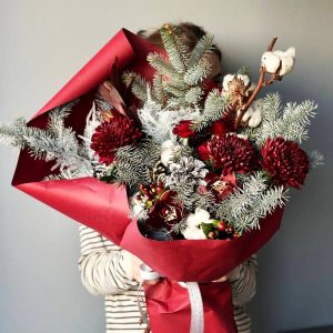Winter Legacy: Bouquet with pine, cotton, spray roses, chrysanthemums, and orchids, creating an impression of winter elegance and beauty.