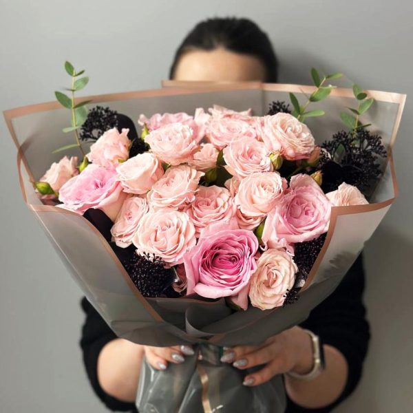 Rose Radiance: A captivating bouquet showcasing roses, spray roses, and skimmia, creating a radiant and elegant floral arrangement.