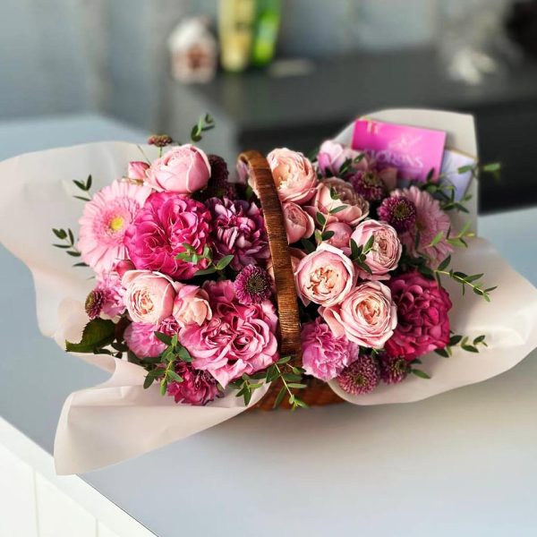 Floral Basket: An elegant bouquet with roses, spray roses, gerbera, dianthus, chrysanthemums, and eucalyptus in a beautiful basket.