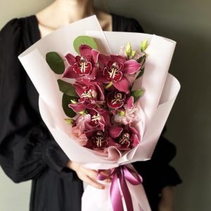 Valentine's Romance with Orchids & Eucalyptus: A luxurious arrangement featuring elegant orchids and aromatic eucalyptus, perfect for igniting the flames of romance on Valentine's Day.