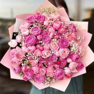 Peony Spray Roses Ensemble: A captivating arrangement featuring peony-like spray roses accented with delicate gypsophila.