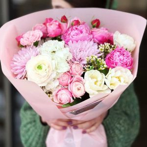 Spring Symphony Bouquet showcasing peonies, tulips, spray roses, ranunculuses, chrysanthemums, hydrangeas, dianthuses, and wax flowers for a vibrant and enchanting display.