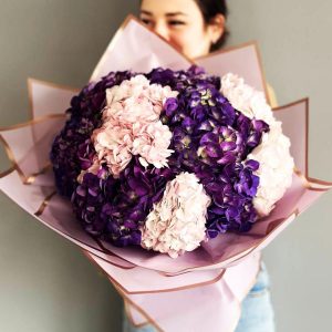 Violet Harmony of Hydrangeas Bouquet showcasing lush hydrangea blooms in a range of captivating colors for an elegant and charming display.