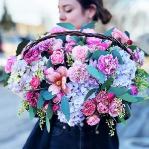Elegant Garden Basket Bouquet showcasing lush hydrangeas, whimsical spray roses, classic roses, vibrant tulips, fragrant eucalyptus, and delicate dianthuses in a charming basket arrangement.