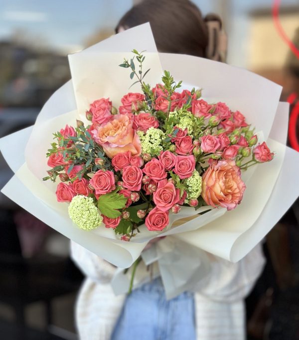 A stunning bouquet of assorted flowers including lilies, sunflowers, and roses, arranged in a captivating display, perfect for gifting or adding a touch of natural beauty to any setting.