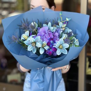 Image of 'Magic Flowers' bouquet showcasing a delightful blend of hydrangeas, eryngium, tulips, and dendrobium orchids, perfect for adding enchantment to any setting.