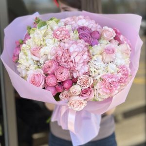 Image of 'Blooming Dreams' bouquet showcasing a vibrant array of roses, hydrangeas, spray roses, and carnations, perfect for adding elegance and charm to any occasion.