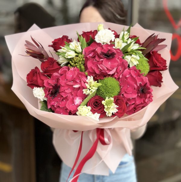 Beautiful bouquet 'Garden Delights' featuring a variety of seasonal blooms and lush green foliage, perfect for weddings and special occasions.