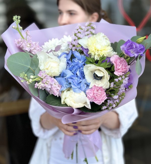 Colorful bouquet 'Bloom Ensemble' showcasing a variety of vibrant flowers against a neutral background.