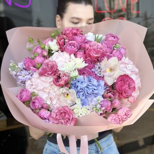 Charming bouquet of delicate blooms in the 'Blossom Song' arrangement, showcasing elegance and springtime beauty.