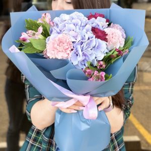 Bright and vibrant bouquet featuring a mix of seasonal blooms in the 'Spring Garden Song' arrangement, capturing the essence of a blooming garden.