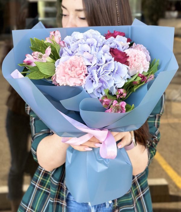 Bright and vibrant bouquet featuring a mix of seasonal blooms in the 'Spring Garden Song' arrangement, capturing the essence of a blooming garden.