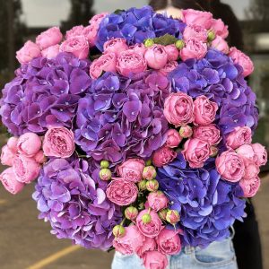 Striking bouquet of purple and violet blooms in the 'Violet Explosion' arrangement, adding dramatic flair and elegance.