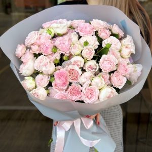 A charming bouquet titled "Pastel Paradise," featuring delicate spray roses in soft shades of pink and cream, elegantly arranged and gently wrapped.